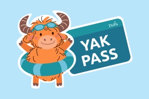 the new YAK Pass mascot, a yak, wearing a pair of goggles on his forehead and a flotation device around his waist.. 